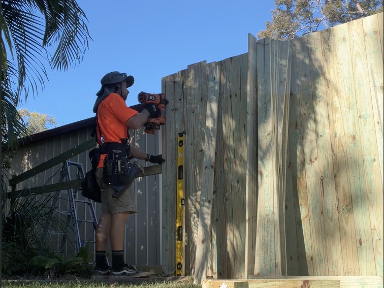 Andy installing a timber gate and fencing at a local property